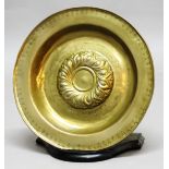 NUREMBERG STYLE BRASS ALMS DISH, probably late 17th or 18th century, the embossed centre