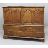 GEORGIAN OAK CUPBOARD ON STAND, probably originally a dowry chest, the pair of doors with arching