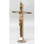 CARVED WOOD CRUCIFIX, probably 19th century, mounted on a stained pine cross, height of figure 36cm