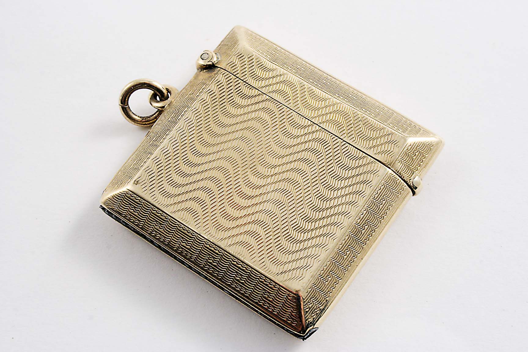A 9 CT. GOLD SQUARE VESTA CASE with engine-turned decoration by Britton & Sons, Birmingham 1925; 1.
