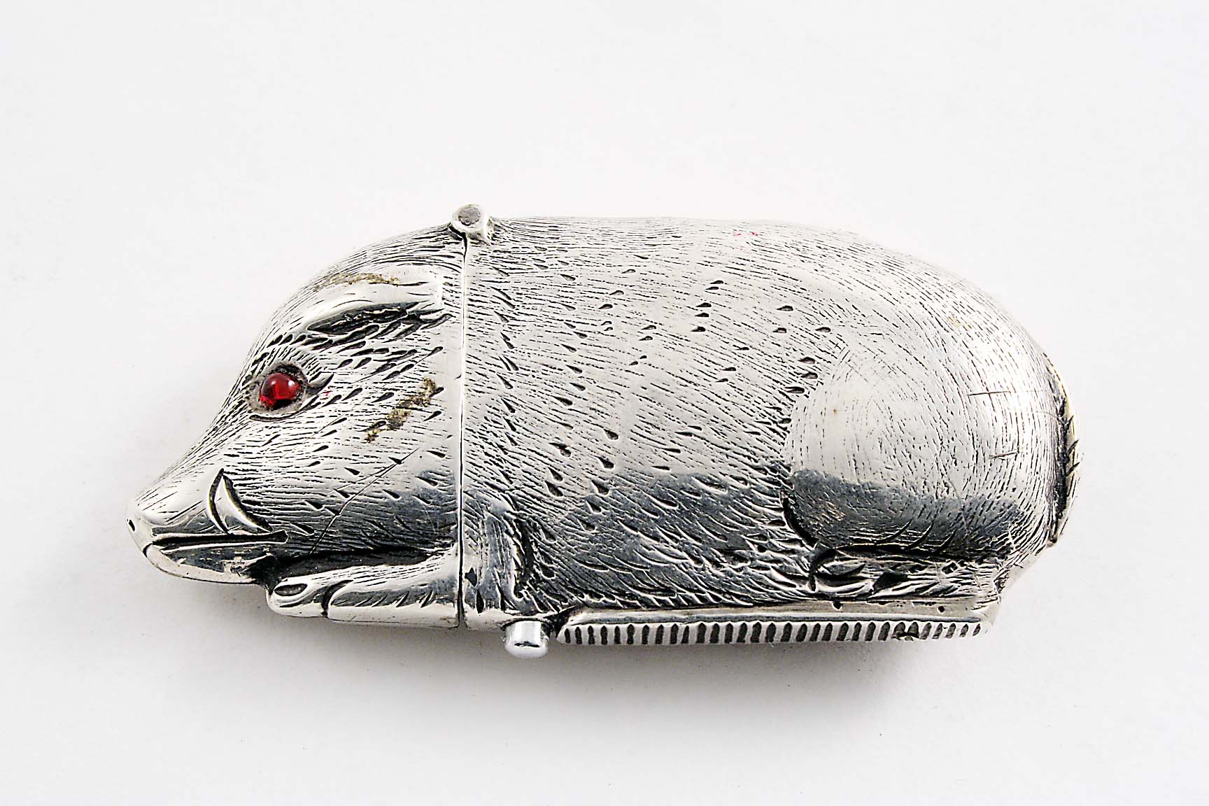 A VICTORIAN SILVER VESTA CASE in the form of a boar with red glass eyes, by Stokes & Ireland,