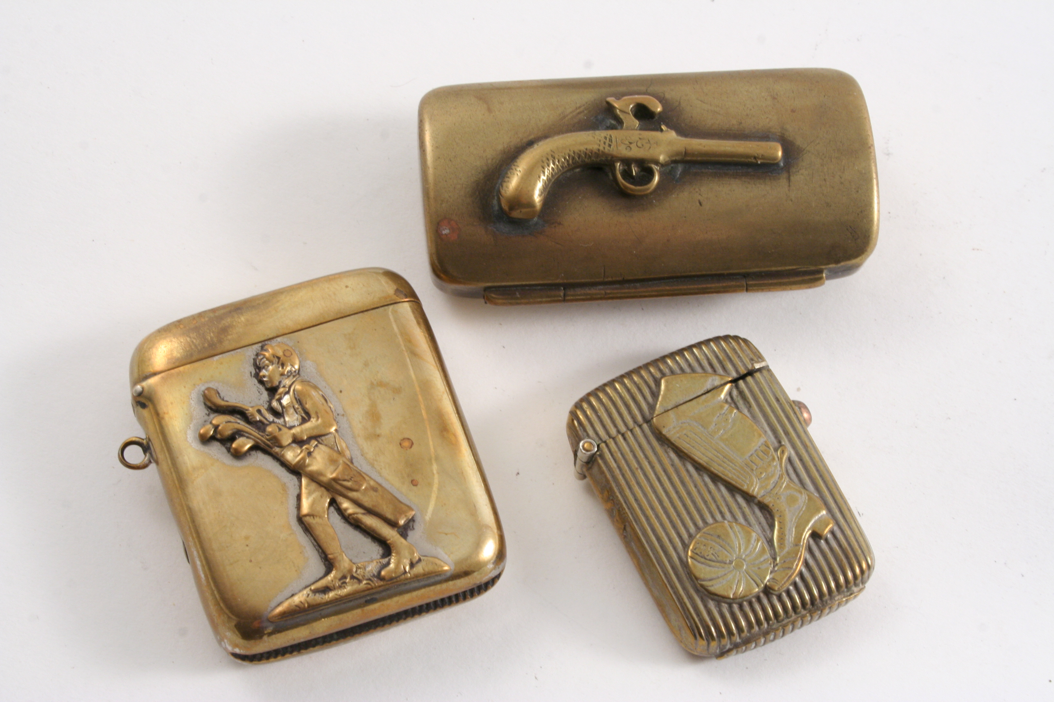 A LATE VICTORIAN BRASS VESTA CASE with a footballer's leg and a ball on the front in low relief,