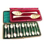 AN EDWARDIAN CASED SET OF TWELVE COFFEE SPOONS each stamped with images representing the signs of