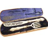 A CASED PAIR OF VICTORIAN FISH SERVERS with a pierced and engraved blade and tines, and loaded