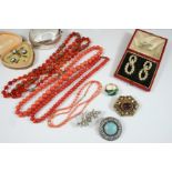 A RED LEATHER JEWELLERY CASE containing a pair of Victorian pearl set drop earrings, 4cm. long,