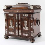 REGENCY ROSEWOOD TABLE CABINET with sarcophagus top, turned rails and mother-of-pearl inlay, the