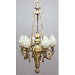 GILT BRONZE SIX LIGHT CHANDELIER, the foliate boss supporting four swags, a central flame finial