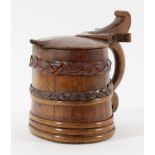 NORWEGIAN BIRCH AND PINE PEG TANKARD of oval form and bound in leather strips, with scrolling