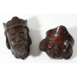 TWO CARVED HEADS the first in oak of a monarch, 13cm, the second in walnut, 10cm (2)