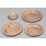 SET OF TWENTY FOUR HAMMERED COPPER PLATES, George III style, comprising eight dinner, dessert and