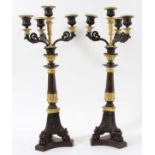 PAIR EMPIRE STYLE BRONZE AND GILT THREE BRANCH CANDELABRA with urn-shaped sconces above scrolling