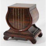 REGENCY ROSEWOOD TEA CADDY of lyre form with brass inlaid 'strings', hidden drawer to one side and