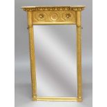REGENCY STYLE GILT PIER MIRROR, the rectangular plate beneath a flower head frieze and flanked by