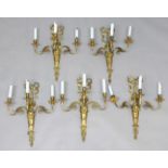 SET OF FIVE GILT BRASS THREE BRANCH WALL LIGHTS the amphora shaped body applied with a mask and