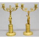 PAIR OF EMPIRE STYLE GILT BRASS CANDELABRA, 19th century, a classical figure standing before a