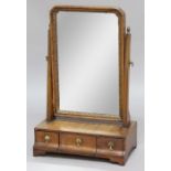 GEORGIAN WALNUT TOILET MIRROR, probably 18th century, the rectangular plate on a base with three