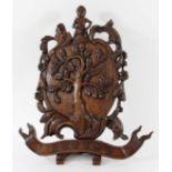 CARVED OAK PANEL bearing an oak tree crest and the motto 'Defend', height 48cm