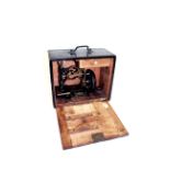 CASED SEWING MACHINE - WEIR a small cast iron sewing machine in a fitted wooden case, with a drawers