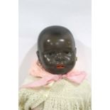 ERNST HEUBACH BLACK DOLL a large black doll with weighted brown eyes, open mouth and pierced ears.