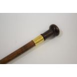 GOLD MOUNTED WALKING STICK a walking stick with a turned wooden handle and wooden shaft, mounted