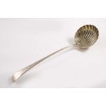 A GEORGE III FEATHER-EDGE SOUP LADLE with a fluted shell bowl, initialled and crested, by Thomas &