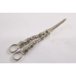 A PAIR OF VICTORIAN CAST GRAPE SHEARS the handles each incorporating an apostle-like figure, with