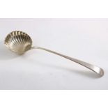 A GEORGE III FEATHER-EDGE SOUP LADLE with a fluted circular bowl, maker's mark "I.S"?, London