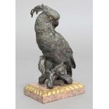 20TH CENTURY SCHOOL, Parrot on a branch, hollow cast bronze with glass eyes, on pink granite base