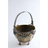 A LATE 19TH CENTURY GERMAN PIERCED BASKET on four feet with a fixed handle & rams' masks around