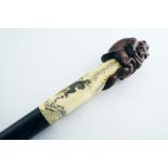 A LATE 19TH / EARLY 20TH CENTURY JAPANESE WALKING STICK with a thick, ebonised shaft & a horn tip,