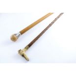 AN EARLY 20TH CENTURY SILVER MOUNTED MALACCA WALKING CANE with an ivory ball finial and a country-