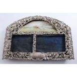 A VICTORIAN OPENWORK PHOTOGRAPH FRAME with an arched top, on a hunting theme with mounted