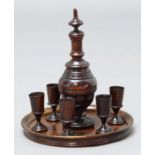 TREEN DECANTER SET, comprising turned, three-sectional decanter, six cups and a circular tray,