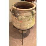 PAIR OF TERRACOTTA AMPHORA PLANTERS, with raised decoration, on iron stands, total height 80cm (2)