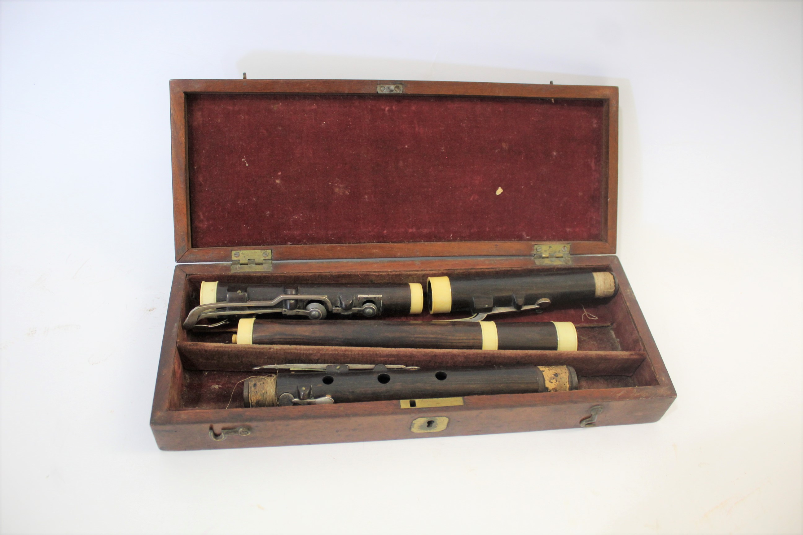 CASED 19THC FLUTE - W BARK, LONDON a 19thc rosewood flute, in four sections and with ivory joins.