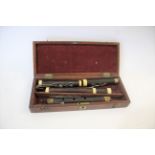 CASED 19THC FLUTE - W BARK, LONDON a 19thc rosewood flute, in four sections and with ivory joins.