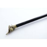 A LATE 19TH / EARLY 20TH CENTURY DEFENSIVE CANE with a brass terminal cast in the form of the head