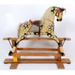 ANTIQUE ROCKING HORSE a small painted rocking horse on a wooden trestle base, some damages. 95cms