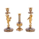 A Pair of Champleve Decorated Gilt Bronze Figural Candlesticks