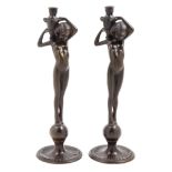 A Pair of Patinated Metal Figural Candlesticks