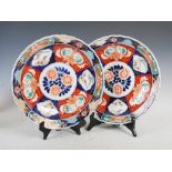 A pair of Japanese Imari chargers, late 19th/early 20th century, decorated with circular panels