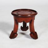 A Chinese dark wood vase stand, the circular top raised on three concave supports with ruyi carved