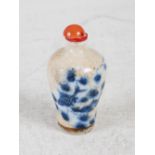 A Chinese porcelain blue and white crackle glazed snuff bottle and stopper, decorated with fish, the
