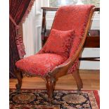 A 19th century rosewood parlour chair, the velvet upholstered back and seat raised on scroll