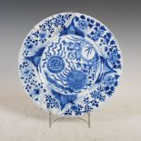 A Chinese porcelain blue and white plate, Kangxi, decorated with rockwork issuing flowers and