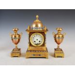 A late 19th/early 20th century gilt metal and champleve enamel clock garniture, the clock with a