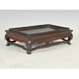 A Chinese dark wood rectangular stand, probably early Qing Dynasty, 27cm wide x 8cm high x 17cm