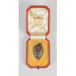 An early 20th century yellow and white metal ruby and diamond leaf shaped clip brooch by Cartier,