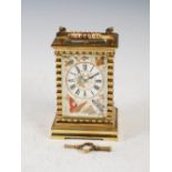 A late 19th/ early 20th century porcelain mounted repeating brass carriage clock, the dial with