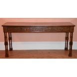 A George III style mahogany serving table, the later rectangular top above a frieze with blind